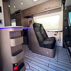 Vue intérieure of modern fourgon aménagé with LED accents and twin bench seats